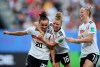 Germany's Lina Magull, left, celebrates with teammates Linda Dallmann, middle, and Lea Schueller after scoring her side's first goal during the of the Women's World Cup quarterfinal soccer match between Germany and Sweden at Roazhon Park in Rennes, France, Saturday, June 29, 2019. (AP Photo/David Vincent)