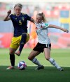 Sweden's Nilla Fischer, left, challenges for the ball with Germany's Lea Schueller during the of the Women's World Cup quarterfinal soccer match between Germany and Sweden at Roazhon Park in Rennes, France, Saturday, June 29, 2019. (AP Photo/David Vincent)