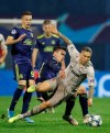 Shakhtar's Marlos, right, and Dinamo Zagreb's Nikola Moro, center, challenge for the ball during the group C Champions League soccer match between Dinamo Zagreb and Shakhtar Donetsk at Maksimir Stadium in Zagreb, Croatia, Wednesday, Nov. 6, 2019. (AP Photo/Darko Bandic)