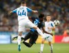 Brugge's David Okereke, right, and Dynamo Kiev's Tamas Kadar challenge for the ball during the Champions League third qualifying round, second leg, soccer match between Dynamo Kyiv and Club Brugge at the Olympiyskiy stadium in Kiev, Ukraine, Tuesday, Aug. 13, 2019. (AP Photo/Efrem Lukatsky)