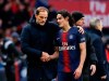 PSG coach Thomas Tuchel and PSG's Edinson Cavani speak during the French League One soccer match between Paris Saint-Germain and Bordeaux at the Parc des Princes stadium in Paris, Saturday, Feb. 9, 2019. (AP Photo/Christophe Ena)
