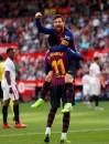 Barcelona forward Lionel Messi with his teammate Ousmane Dembele celebrate after scoring his side's second goal during La Liga soccer match between Sevilla and Barcelona at the Ramon Sanchez Pizjuan stadium in Seville, Spain. Saturday, February 23, 2019. (AP Photo/Miguel Morenatti)