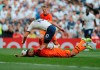 Tottenham's Harry Kane falls after he was tackled by Newcastle's Jamaal Lascelles during the English Premier League soccer match between Tottenham Hotspur and Newcastle United at Tottenham Hotspur Stadium in London, Sunday, Aug. 25, 2019.(AP Photo/Frank Augstein)