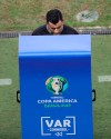 Referee Roberto Tobar watches the VAR monitor during a Copa America quarterfinal soccer match between Brazil and Paraguay at Arena do Gremio in Porto Alegre, Brazil, Thursday, June 27, 2019. (AP Photo/Ricardo Mazalan)