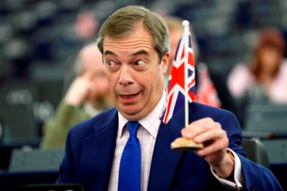 Former U.K. Independence Party (UKIP) leader and member of the European Parliament Nigel Farage holds a U.K. flag during a plenary session at the European Parliament in Strasbourg, eastern France, Wednesday, March 13, 2019. British lawmakers rejected May's Brexit deal in a 391-242 vote on Tuesday night. Parliament will vote Wednesday on whether to leave the EU without a deal. (AP Photo/Jean Francois Badias)