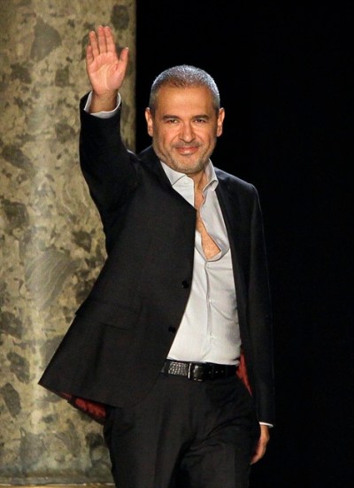 Fashion designer Elie Saab acknowledges applause from the audience at the end of his Women's Fall Winter 2013 haute couture fashion collection in Paris, France, Wednesday, July 4, 2012. (AP Photo/Francois Mori)