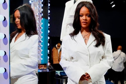 Singer Rihanna, the first black woman in history to head up a major Parisian luxury house, poses as she unveiled her first fashion designs for Fenty at a pop-up store in Paris, France, Wednesday, May 22, 2019. The collection, named after the singer turned designer's last name, comprises ready-to-wear, footwear, accessories, and eyewear and is available for sale Paris' Le Marais area from Friday and will debut online May 29. (AP Photo/Francois Mori)