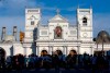 People gather outside St. Anthony's Shrine, a day after a blast in Colombo, Sri Lanka, Monday, April 22, 2019. Easter Sunday bombings of churches, luxury hotels and other sites was Sri Lanka's deadliest violence since a devastating civil war in the South Asian island nation ended a decade ago. (AP Photo/Gemunu Amarasinghe)