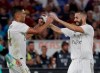 Real midfielder Casemiro, left, celebrates with teammate Karim Benzema after scoring his team's second goal during a friendly soccer match between Roma and Real Madrid, at the Olympic stadium in Rome, Sunday, Aug. 11, 2019. (AP Photo/Gregorio Borgia)