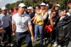 Rory McIlroy of Northern Ireland tries to get past fans on the final day of the HSBC Champions golf tournament held at the Sheshan International Golf Club in Shanghai on Sunday, Nov. 3, 2019. (AP Photo/Ng Han Guan)