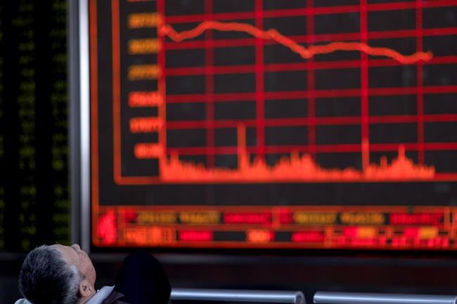 A Chinese investor watches as the Shanghai Composite Index falls at a brokerage In Beijing on Monday, May 6, 2019. China's benchmark Shanghai Composite index dives on Trump threat of more China tariffs. (AP Photo/Ng Han Guan)