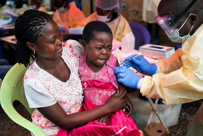 In this photograph taken Saturday July 13, 2019, A girl receives the Ebola vaccine in Beni, Congo DRC. The head of the World Health Organization is convening a meeting of experts Wednesday July 17, 2019 to decide whether the Ebola outbreak should be declared an international emergency after spreading to eastern Congo's biggest city, Goma, this week. More than 1,600 people in eastern Congo have died as the virus has spread in areas too dangerous for health teams to access. (AP Photo/Jerome Delay)