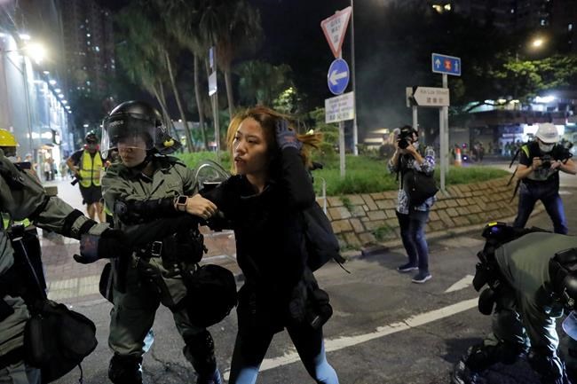 A protester is detained by police during a protest in Hong Kong on Saturday, Sept. 21, 2019. Protesters in Hong Kong burned a Chinese flag and police fired pepper spray Saturday in renewed clashes over grievances by the anti-government demonstrators. (AP Photo/Kin Cheung)