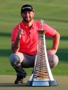 Jon Rahm of Spain poses with the Race to Dubai trophy after he won the golf tournament in Dubai, United Arab Emirates, Sunday, Nov. 24, 2019. (AP Photo/Kamran Jebreili)