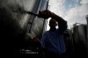 In this image taken on Monday, Oct. 15, 2018, wine grower Adelino Pizzobon spills Prosecco from a silos, at the Case Paolin farm, in Volpago del Montello, Italy. Prosecco has become the best-selling sparkling wine in the world, and experts say it is eroding the more casual corner of champagne's market while aiming higher. Its production eclipsed champagne's five years ago and is now 75 percent higher at 544,000 bottles three-quarters of which for export. (AP Photo/Luca Bruno)