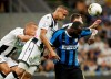 Inter Milan's Romelu Lukaku, right, heads the ball flanked by Udinese's Mato Jajalo, Rodrigo Becao, center, and Udinese's Sebastien De Maio, left, during a Serie A soccer match between Inter Milan and Udinese, at the San Siro stadium in Milan, Italy, Saturday, Sept. 14, 2019. (AP Photo/Luca Bruno)