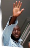 Soccer forward Romelu Lukaku waves at Inter Milan supporters from a window of the Italian Olympic Committee's headquarters, in Milan,Italy, Thursday, Aug. 8, 2019. Manchester United forward Lukaku is on the verge of completing his move to Inter Milan on the final day of transfers in England. (AP Photo/Luca Bruno)