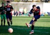 A Desio player, his face painted with black marks as a symbolic sign against racism, kicks the ball during a youth team soccer match between Desio and Sovicese at the municipal stadium in Desio, near Milan, Italy, Saturday, Nov. 9, 2019. The initiative comes a week after a 10-year-old member of the Aurora Desio team was allegedly subjected to racist abuse during a match. (AP Photo/Luca Bruno)