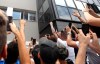 Inter Milan supporters wave as soccer forward Romelu Lukaku gives them a thumbs up sign from a window of the Italian Olympic Committee's headquarters, in Milan, Italy, Thursday, Aug. 8, 2019. Manchester United forward Lukaku is on the verge of completing his move to Inter Milan on the final day of transfers in England. (AP Photo/Luca Bruno)