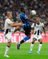 Inter Milan's Romelu Lukaku, center, controls the ball during a Serie A soccer match between Inter Milan and Udinese, at the San Siro stadium in Milan, Italy, Saturday, Sept. 14, 2019. (AP Photo/Luca Bruno)