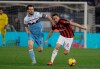 AC Milan's Hakan Calhanoglu , right, challenges for the ball with Lazio's Marco Parolo during the Italian Cup, first leg semifinal soccer match between Lazio and AC Milan at the Olympic stadium in Rome, Italy, Tuesday, Feb.26, 2019. (AP Photo/Gregorio Borgia)