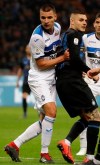 Atalanta's Berat Djimsiti, left, and Inter Milan's Mauro Icardi vie for the ball during an Italian Serie A soccer match between Inter Milan and Atalanta, at the San Siro stadium in Milan, Italy, Sunday, April 7, 2019. (AP Photo/Luca Bruno)