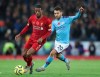 Manchester City's Bernardo Silva, right, challenges for the ball with Liverpool's Georginio Wijnaldum during the English Premier League soccer match between Liverpool and Manchester City at Anfield stadium in Liverpool, England, Sunday, Nov. 10, 2019. (AP Photo/Jon Super)