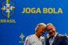 Pia Sundhage from Sweden, left, and Rogerio Caboclo, president of the Brazilian Football Confederation, touch their heads during her announcement as the coach of the Brazilian women's national soccer team, in Rio de Janeiro, Brazil, Tuesday, July 30, 2019. The 59-year-old Sundhage is the first foreigner to coach Brazil. (AP Photo/Leo Correa)