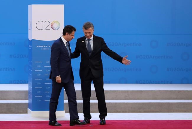 Argentina's President Mauricio Macri, right, welcomes Italy's Prime Minister Giuseppe Conte to the start of the G20 summit in Buenos Aires, Argentina, Friday, Nov. 30, 2018. Leaders from the Group of 20 industrialized nations are meeting in Buenos Aires for two days starting today. (AP Photo/Ricardo Mazalan)