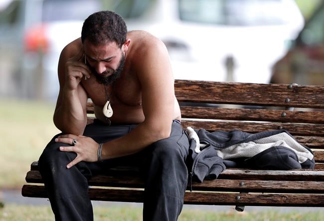 A man reacts as he speaks on a mobile phone near a mosque in central Christchurch, New Zealand, Friday, March 15, 2019. Multiple people were killed in mass shootings at two mosques full of people attending Friday prayers, as New Zealand police warned people to stay indoors as they tried to determine if more than one gunman was involved. (AP Photo/Mark Baker)