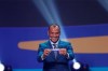 Brazil's former player Cafu olds up the team name of Qatar during the draw for the 2019 Copa America soccer tournament in Rio de Janeiro, Brazil, Thursday, Jan. 24, 2019. Brazil will host the continental soccer tournament in June and July. (AP Photo/Andre Penner)