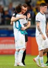 Argentina's Lionel Messi, left, is embraced by goalkeeper Franco Armani at the end of a Copa America Group B soccer match against Paraguay at the Mineirao stadium in Belo Horizonte, Brazil, Wednesday, June 19, 2019. (AP Photo/Natacha Pisarenko)