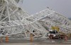 A collapsed metal structure sits on the ground at Itaquerao Stadium in Sao Paulo, Brazil, Wednesday, Nov. 27, 2013. The accident that resulted in the death of at least two workers, occurred when a construction crane crashed into a 500-ton metal structure that in turn cut through the outer walls of the venue, destroying rows of seats and slamming into a massive LED panel that runs across the stadium's facade. The stadium is slated to host the 2014 World Cup opener. (AP Photo/Nelson Antoine)