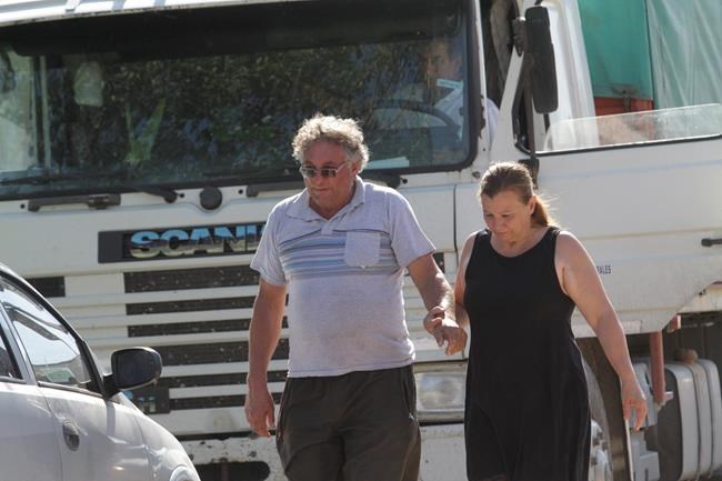 CORRECTS NAME OF PARTNER - Horacio Sala, father of Argentine soccer player Emiliano Sala, holds hands with his partner Liliana Ponce outside their home in Progreso, Argentina, Tuesday, Jan. 22, 2019. The French civil aviation authority says the 28-year-old Argentine striker was aboard a small passenger plane that went missing off the coast of the island of Guernsey on Monday.