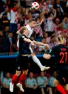 England's Kieran Trippier, right, challenges for the ball with Croatia's Ivan Strinic during the semifinal match between Croatia and England at the 2018 soccer World Cup in the Luzhniki Stadium in Moscow, Russia, Wednesday, July 11, 2018. (AP Photo/Rebecca Blackwell)