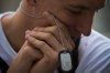 ADDS ID - Afghanistan war veteran Christoffer Molsing, 19, of Denmark, bows his head during a ceremony marking the 10th anniversary of the attacks on the World Trade Center Sunday, Sept. 11, 2011, outside the World Trade Center site in New York. (AP Photo/Oded Balilty)