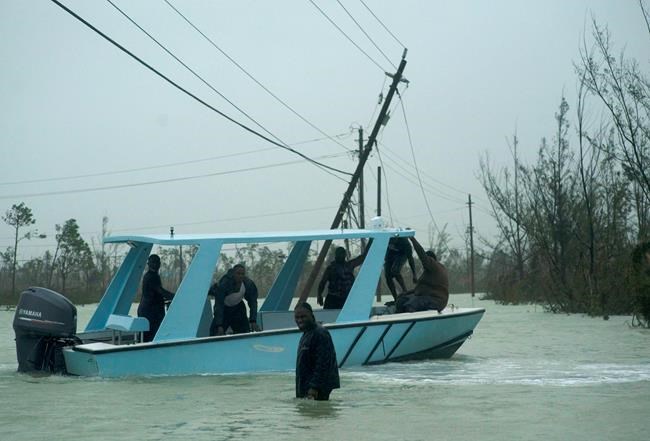 Volunteers depart on a motor-boat to rescue people trapped by the rising waters of Hurricane Dorian, on a flooded road near the Causarina bridge in Freeport, Grand Bahama, Bahamas, Tuesday, Sept. 3, 2019. The storm’s punishing winds and muddy brown floodwaters devastated thousands of homes, crippled hospitals and trapped people in attics. (AP Photo/Ramon Espinosa)