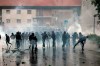 Lazio fans clash with police prior to the Italian Cup final soccer match between Lazio and Atalanta, in Rome, Wednesday, May 15, 2019. A police car was set on fire as Lazio fans clashed with local authorities near the Stadio Olimpico before the Italian Cup final on Wednesday. Italian national news agency Ansa reported that the two policemen who were in the car at the time have been taken to hospital for smoke inhalation, while one also had an injury to his ear. Lazio fans have also been throwing bottles, stones and other objects. (Massimo Percossi/ANSA via AP)