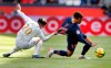 Nice's Youcef Atal, left, and PSG's Juan Bernat challenge for the ball during the French League One soccer match between Paris Saint-Germain and Nice at the Parc des Princes stadium in Paris, France, Saturday, May 4, 2019. (AP Photo/Christophe Ena)