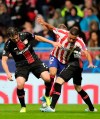 Leverkusen's Julian Baumgartlinger, left, Leverkusen's Mitchell Weiser, right, fight for the ball against Atletico Madrid's Renan Lodi during the Champions League Group D soccer match between Atletico Madrid and Bayer Leverkusen at Wanda Metropolitano stadium in Madrid, Spain, Tuesday, Oct. 22, 2019. (AP Photo/Bernat Armangue)
