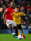 Manchester United's Paul Pogba, left, vies for the ball with Arsenal's Lucas Torreira during the English Premier League soccer match between Manchester United and Arsenal at Old Trafford in Manchester, England, Monday, Sept. 30, 2019. (AP Photo/Dave Thompson)