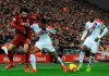 Liverpool's Mohamed Salah, left, and Crystal Palace's Patrick van Aanholt challenge for the ball during the English Premier League soccer match between Liverpool and Crystal Palace at Anfield in Liverpool, England, Saturday, Jan. 19, 2019. (AP Photo/Rui Vieira)