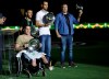 FILE - In this Jan. 25, 2017 file photo, former Chapecoense players Neto, second from right, former goalkeeper Follmann, in wheelchair, Alan Ruschel, behind left, and radio soccer announcer Rafael Henzel, right, all plane crash survivors, are honored prior to a friendly soccer match between Brazil and Colombia at Nilton Santos stadium in Rio de Janeiro, Brazil. Henzel, one of the six passengers that survived in the Nov. 28, 2016, Chapecoense soccer team air crash, which killed 71 people, including 19 players, has died on Tuesday, March 26, 2019. (AP Photo/Silvia Izquierdo, File)