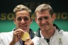 South Africa's swimmers Chad le Clos, left, with Cameron van der Burgh, right, poses with his Olympic gold medal during their arrival at OR Tambo International Airport in Johannesburg, South Africa, on Thursday, Aug. 9, 2012. (AP Photo/Themba Hadebe)