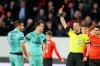 Ivan Kruzliak of Slovakia shows the red card to Arsenal's Sokratis Papastathopoulos, left, during the Europa League round of 16, first leg soccer match between Rennes and Arsenal at Roazhon Park in Rennes, northwestern France, Thursday, March 7, 2019. (AP Photo/David Vincent)