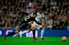 Ajax's Noussair Mazraoui, left, tries to stop Real forward Vinicius Junior during the Champions League round of 16 second leg soccer match soccer match between Real Madrid and Ajax at the Santiago Bernabeu stadium in Madrid, Tuesday, March 5, 2019. (AP Photo/Bernat Armangue)