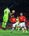 Barcelona's Luis Suarez scores the opening goal of his team during the Champions League quarterfinal, first leg, soccer match between Manchester United and FC Barcelona at Old Trafford stadium in Manchester, England, Wednesday, April 10, 2019. (AP Photo/Jon Super)
