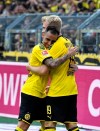 Dortmund's Julian Brandt, right, celebrates after scoring his side's fifth goal during the German Bundesliga soccer match between Borussia Dortmund and FC Augsburg at the Signal Iduna Park stadium in Dortmund, Germany, Saturday, Aug. 17, 2019. (AP Photo/Martin Meissner)