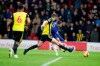 Chelsea's Eden Hazard, back shots the ball past Watford's Craig Cathcart, center during the English Premier League soccer match between Watford and Chelsea at Vicarage Road stadium in Watford, England on Wednesday, Dec. 26, 2018. (AP Photo/Frank Augstein)