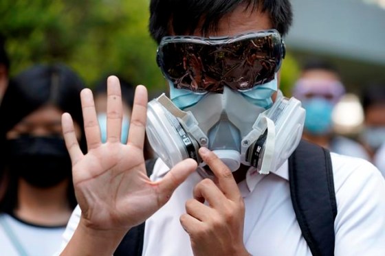 Vincent Thian / The Associated PressA protester wears a gas mask and holds up his hand to represent the protester's five demands in Hong Kong Friday, Oct. 4, 2019. Hong Kong pro-democracy protesters marched in the city center ahead of reported plans by the city’s embattled leader to deploy emergency powers to ban people from wearing masks in a bid to quash four months of anti-government demonstrations. (AP Photo/Vincent Thian)